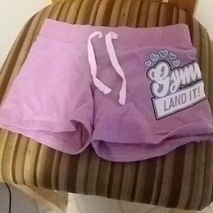 shorts that says "gymmast land it"